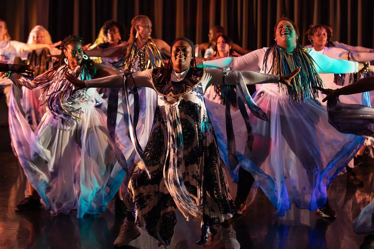 RJC Dance performers on stage in flowing costumes