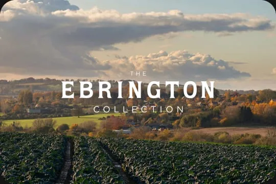 The Ebrington Collection name over Cotswold fields at sunset