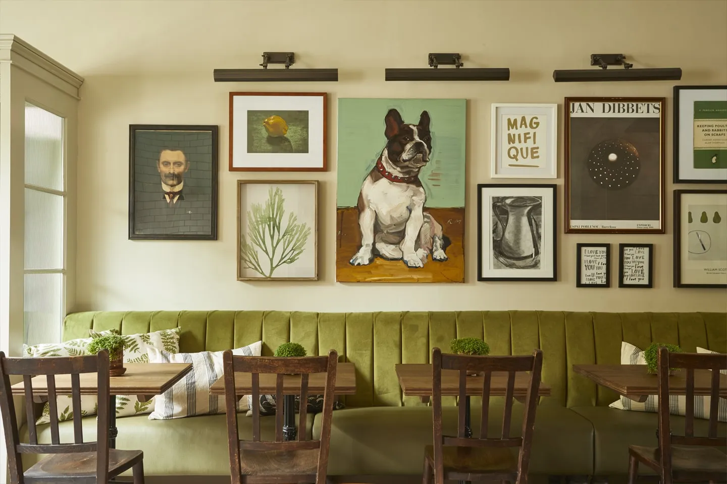 A dining room at the Lime Tree Hotel, with prints on the green walls