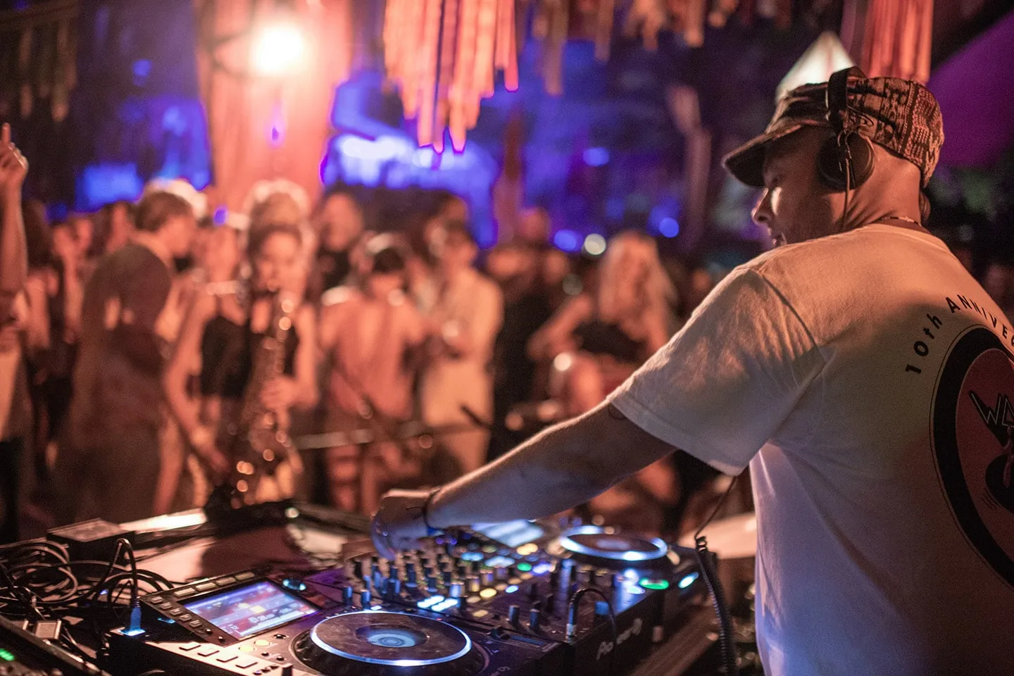 A DJ playing to a packed crowd at a Last Night A DJ Saved My Life event
