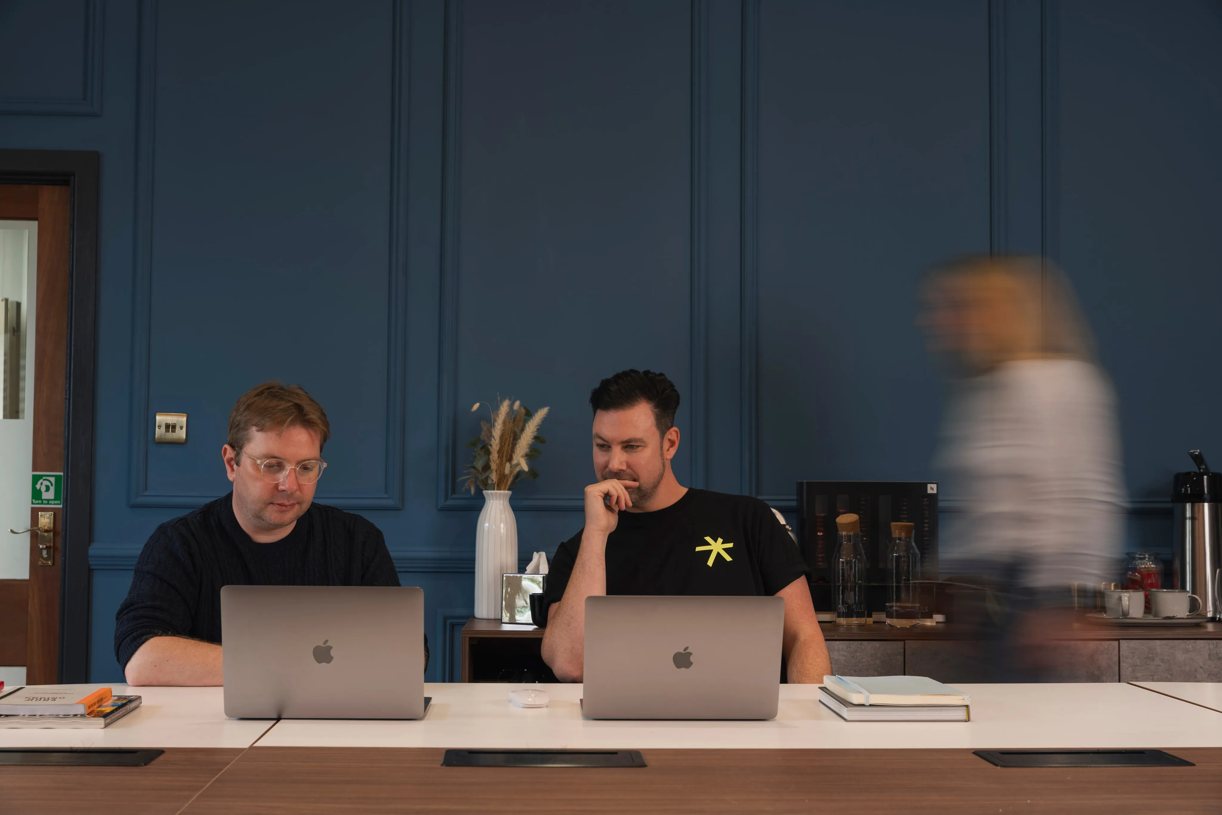 Jonny and Kev working through something together on their laptops