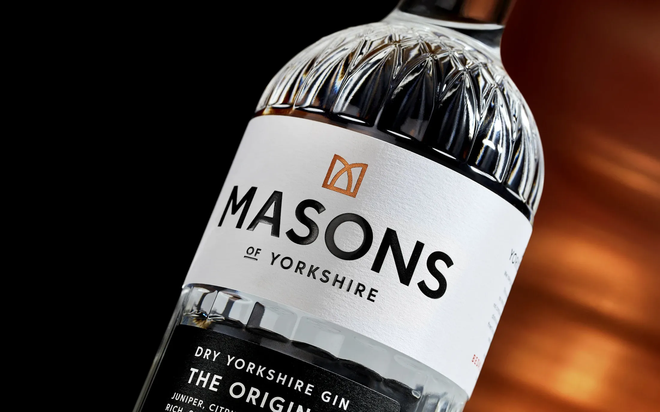 A close-up of a Masons of Yorkshire gin bottle