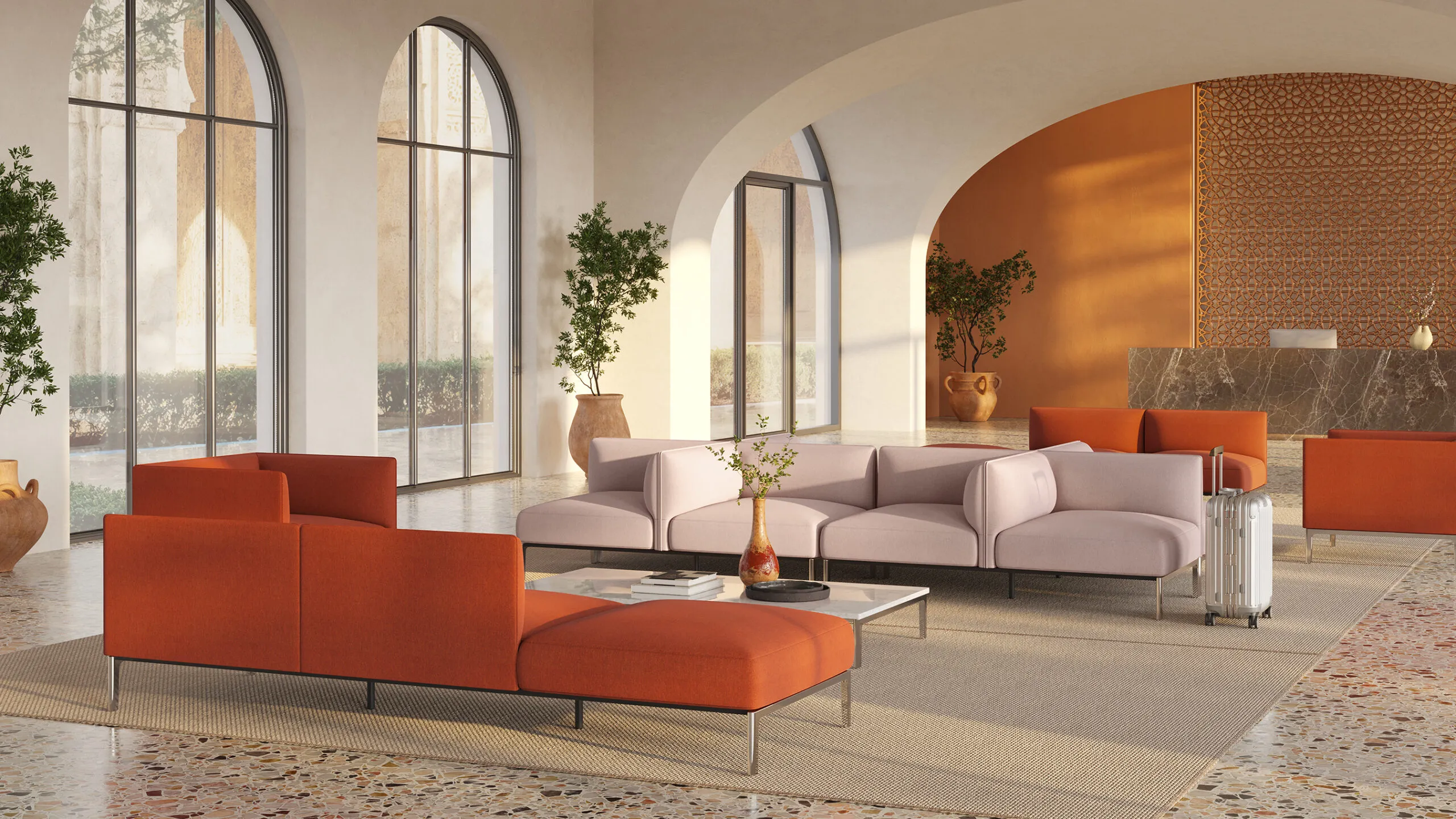 A NaughtOne lounge with orange and pink sofas under arched windows
