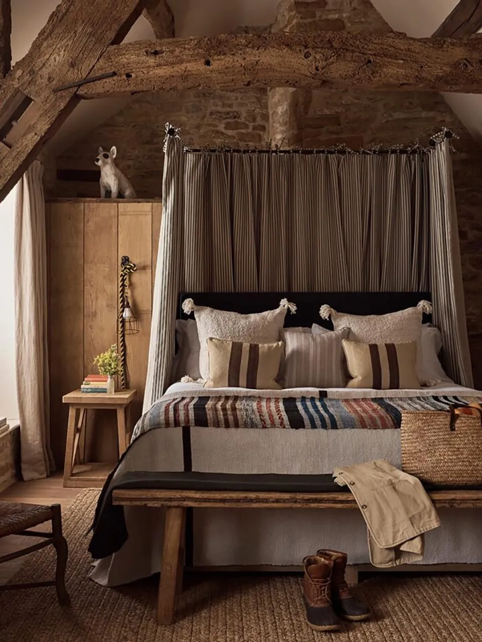 A four-poster bed in a beamed Daylesford bedroom