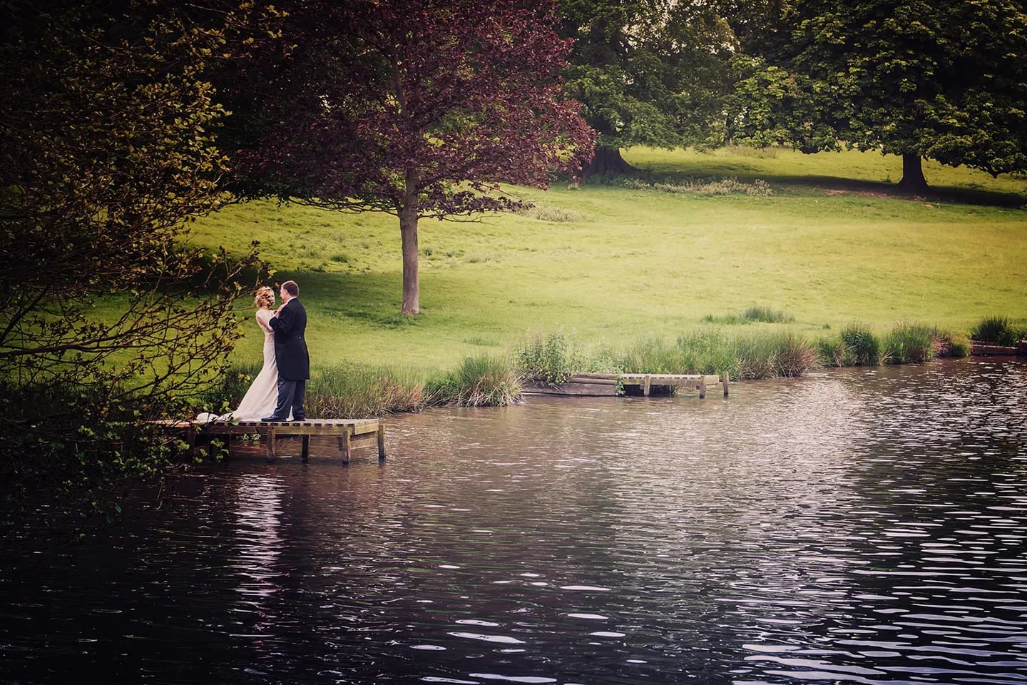 A couple by the lake in the grounds of Ripley Castle