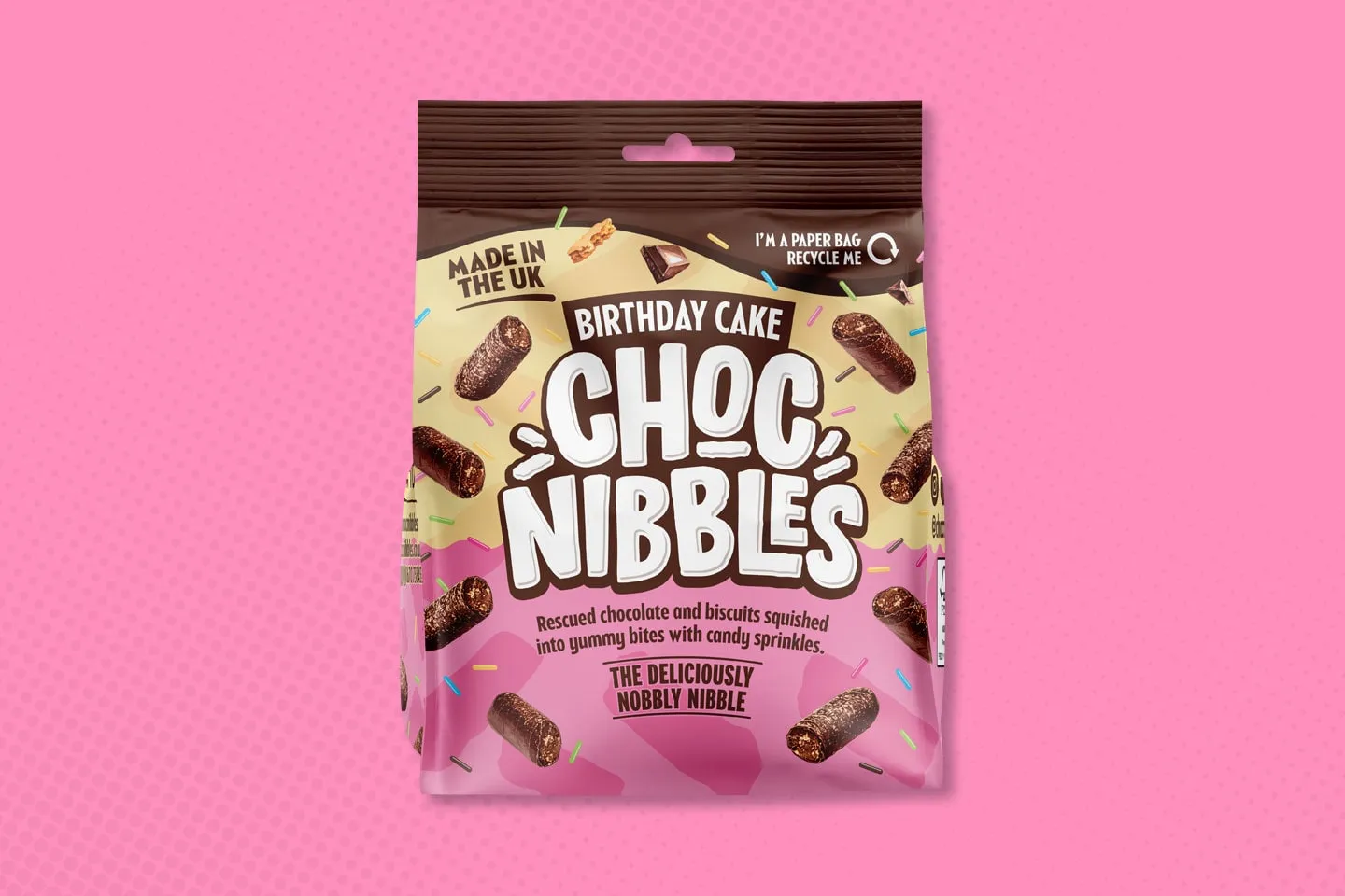 A bag of Choc Nibbles on a pink background