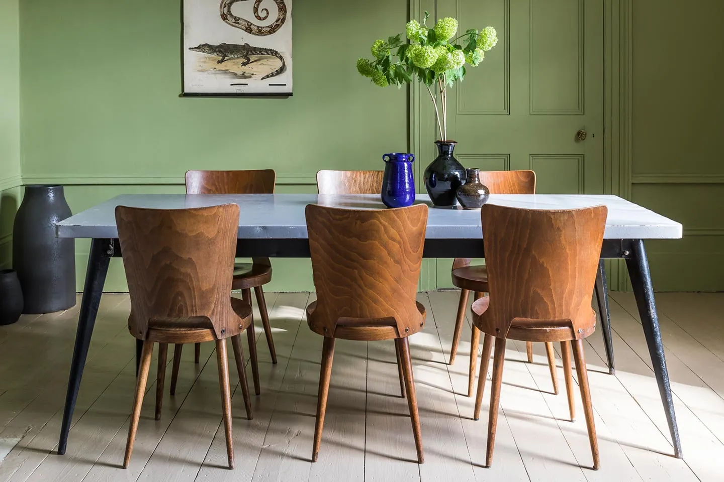 Vintage dining chairs around a long table from Merchant & Found