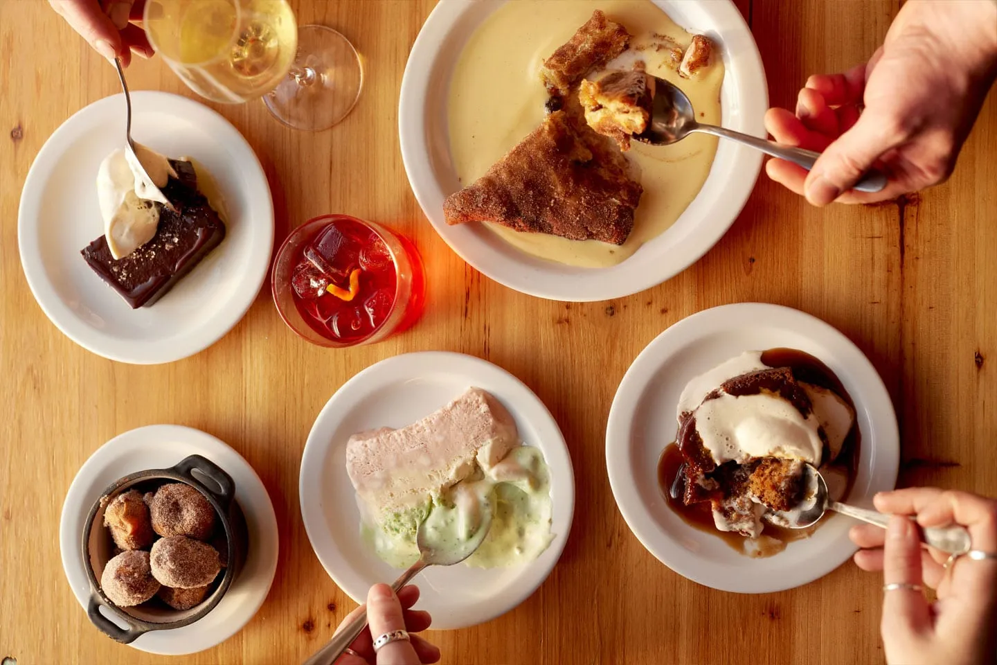 Plates of food shared on a table at Sam & Jak