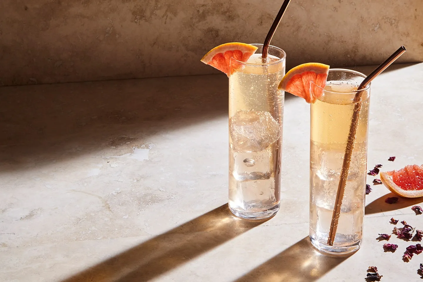 Two Tenjaku highballs with grapefruit on a marble table