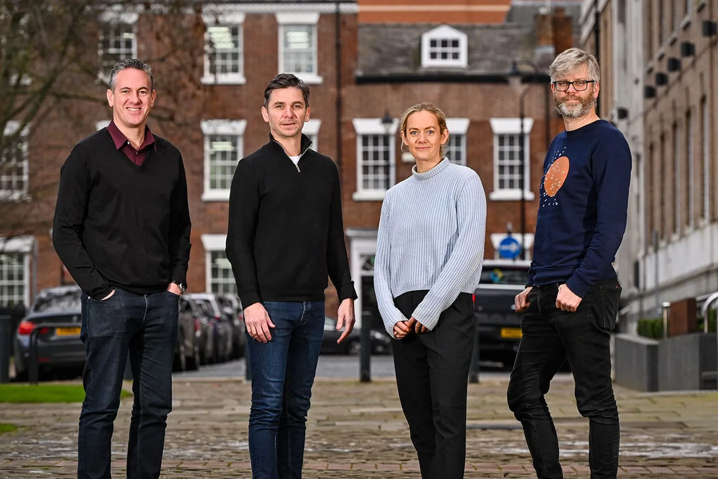 Four of the Source team standing outside their office
