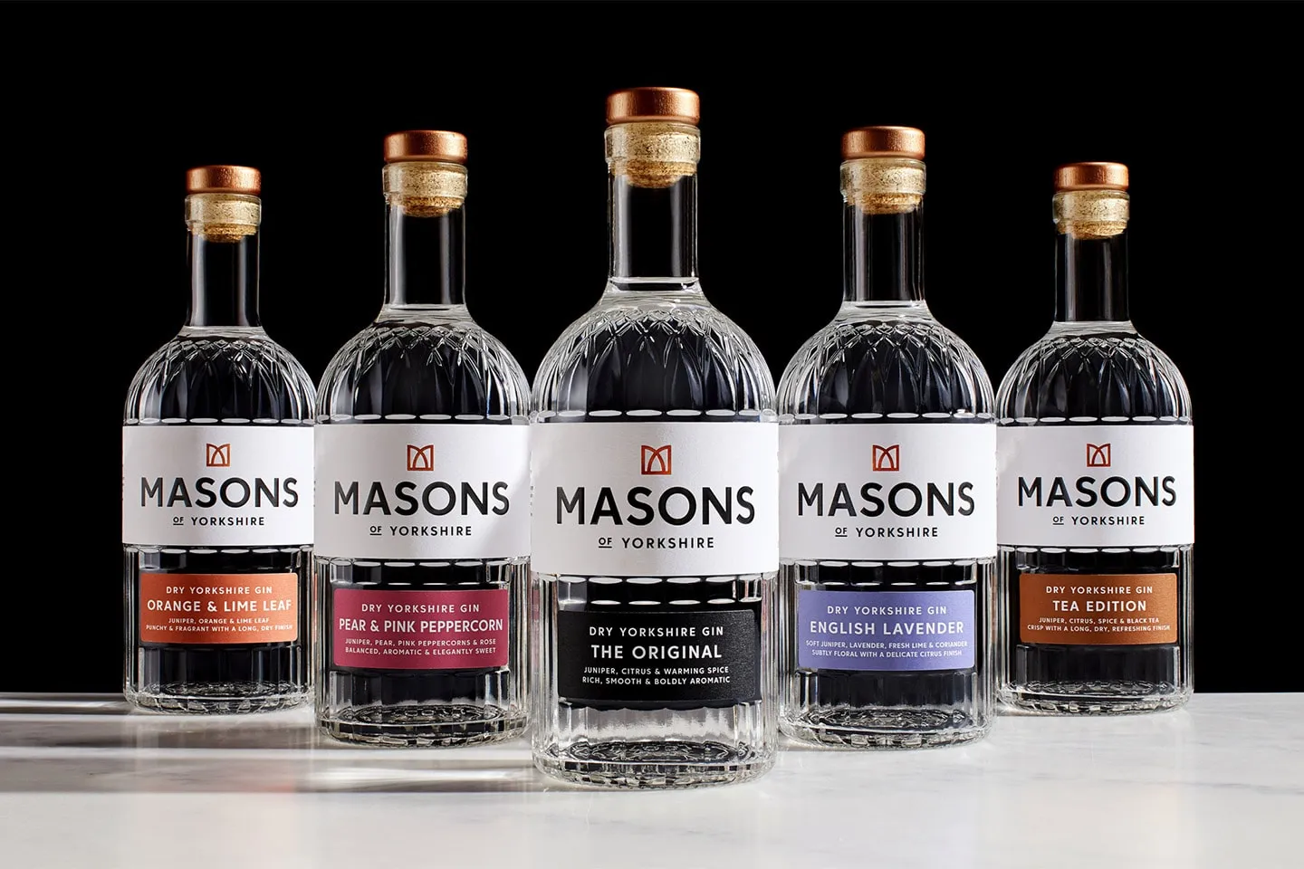 Five bottles of Masons gin in a row