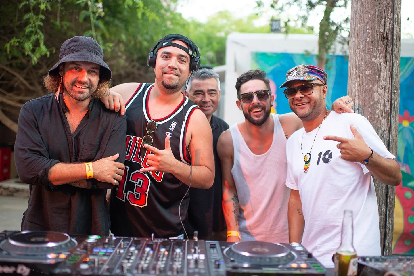 DJs smiling together behind the decks