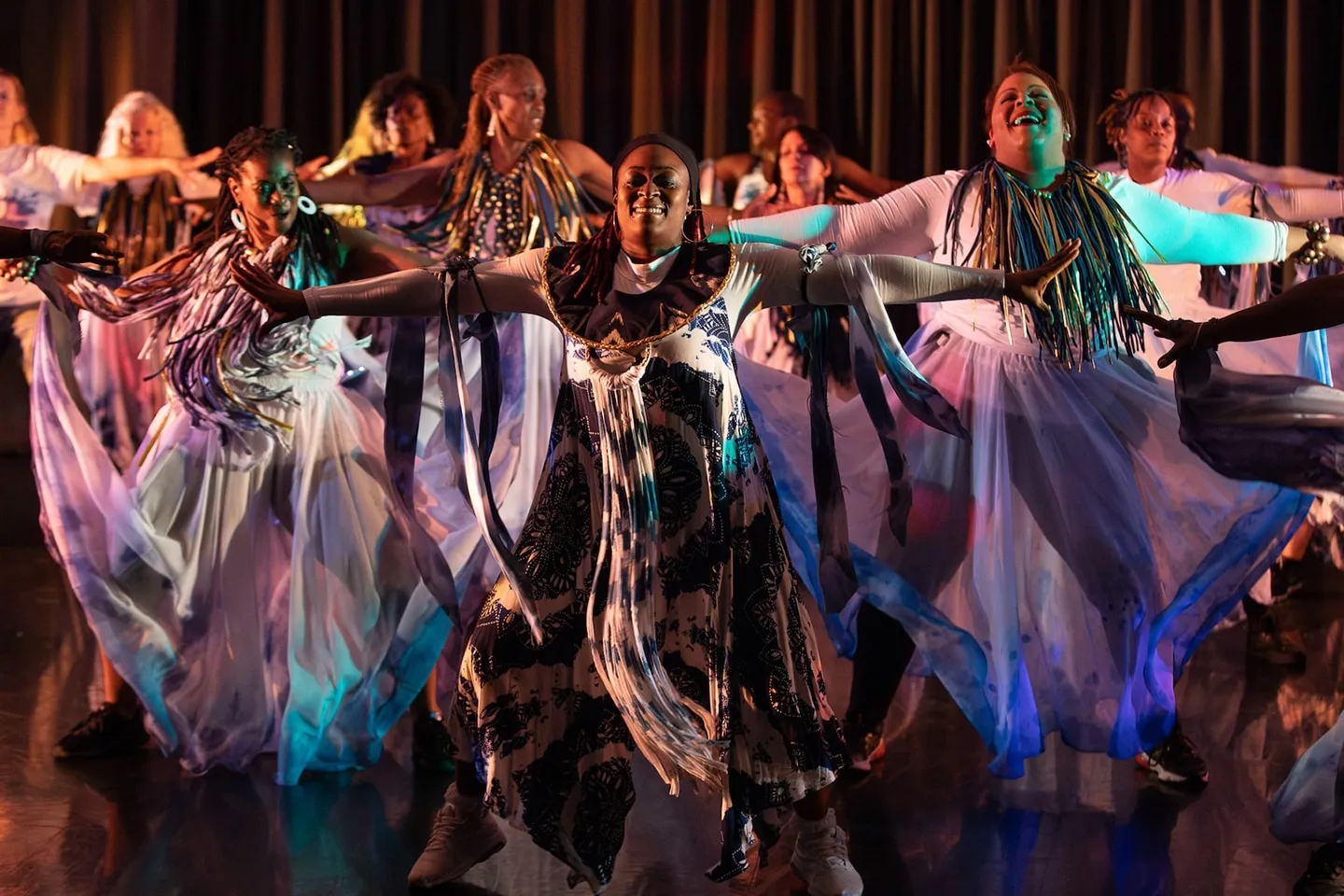 RJC dancers in flowing costumes on stage