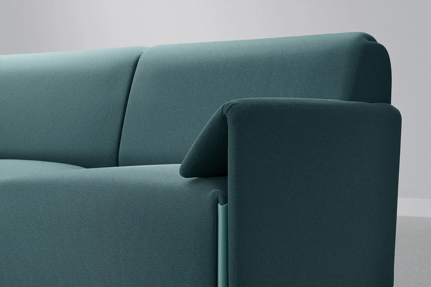 A green upholstered sofa in TextileMania fabric, close up